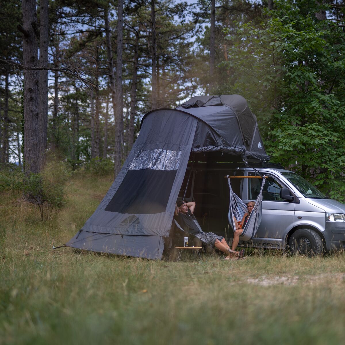 VW Bus mit Vorzelt Light Base und Hängematte am Waldrand